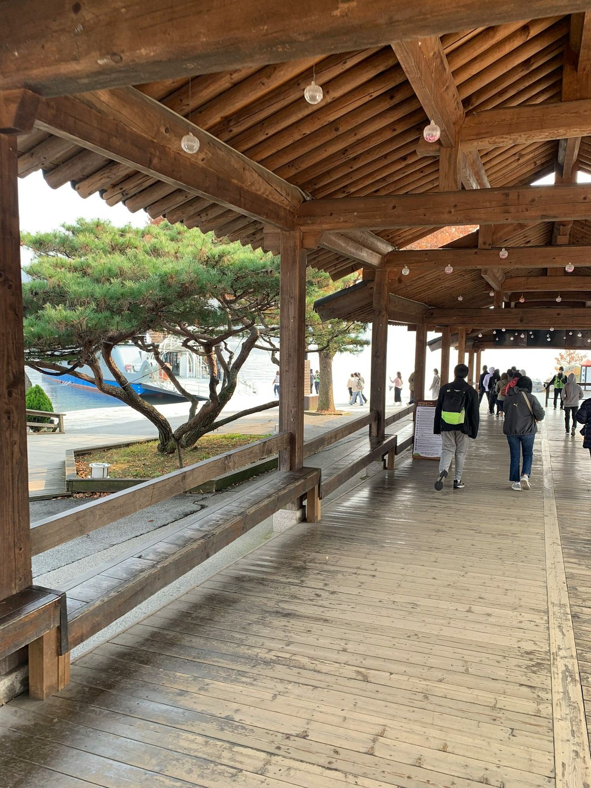 Covered wooden walkway near the ferry pier on Miyajima island