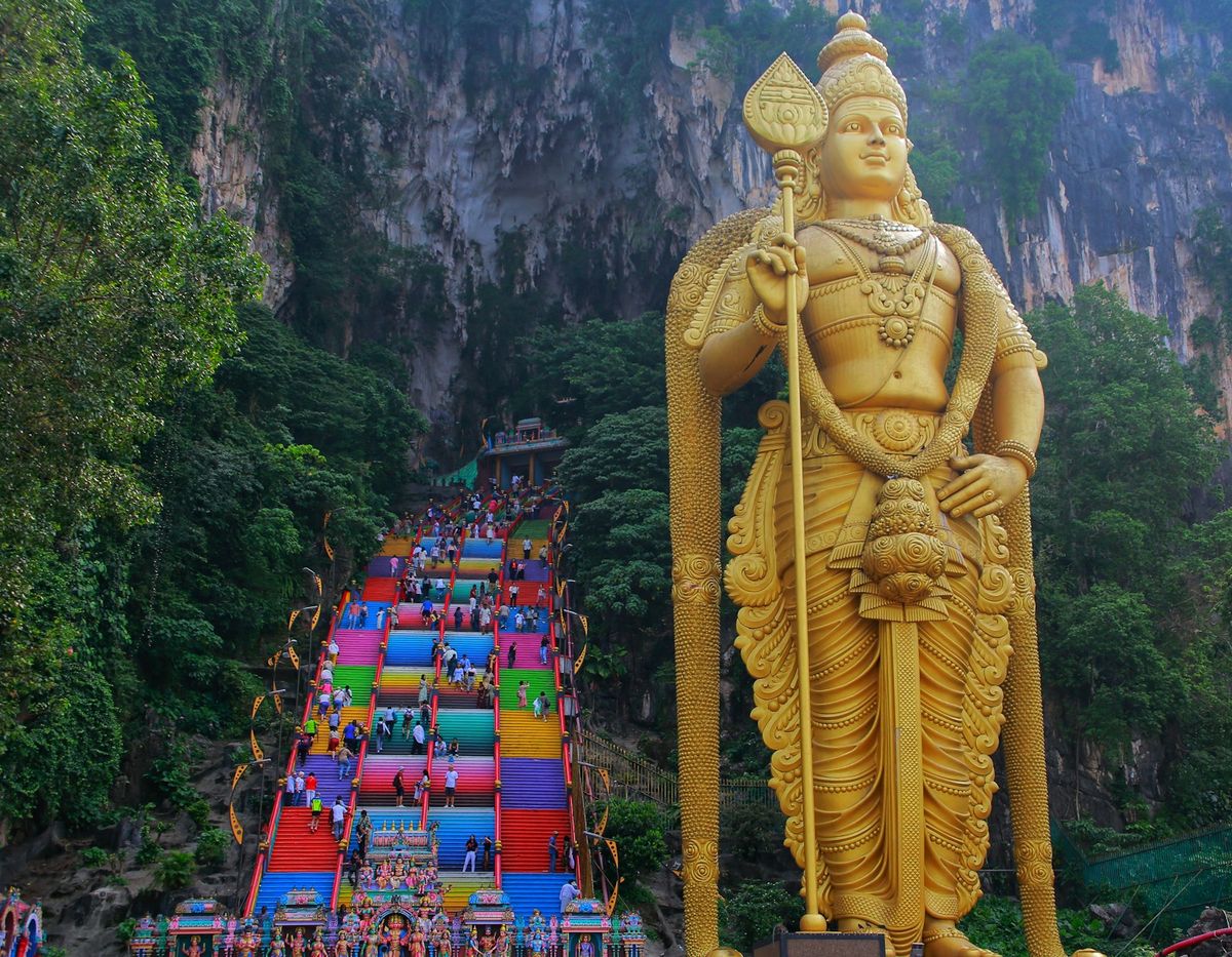 Giant golden Murugan statue at the entrance to Batu Caves Malaysia