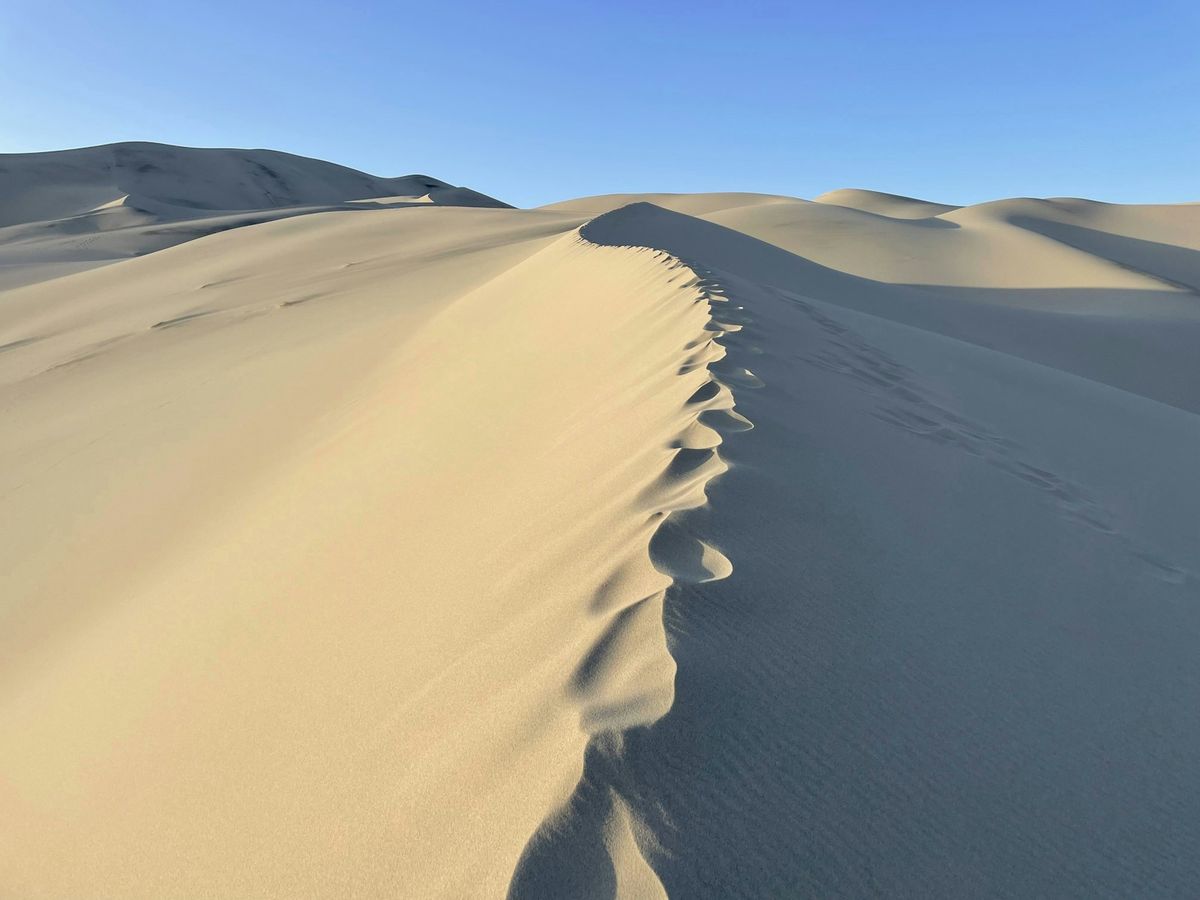 Golden sand dunes stretching across Death Valley National Park