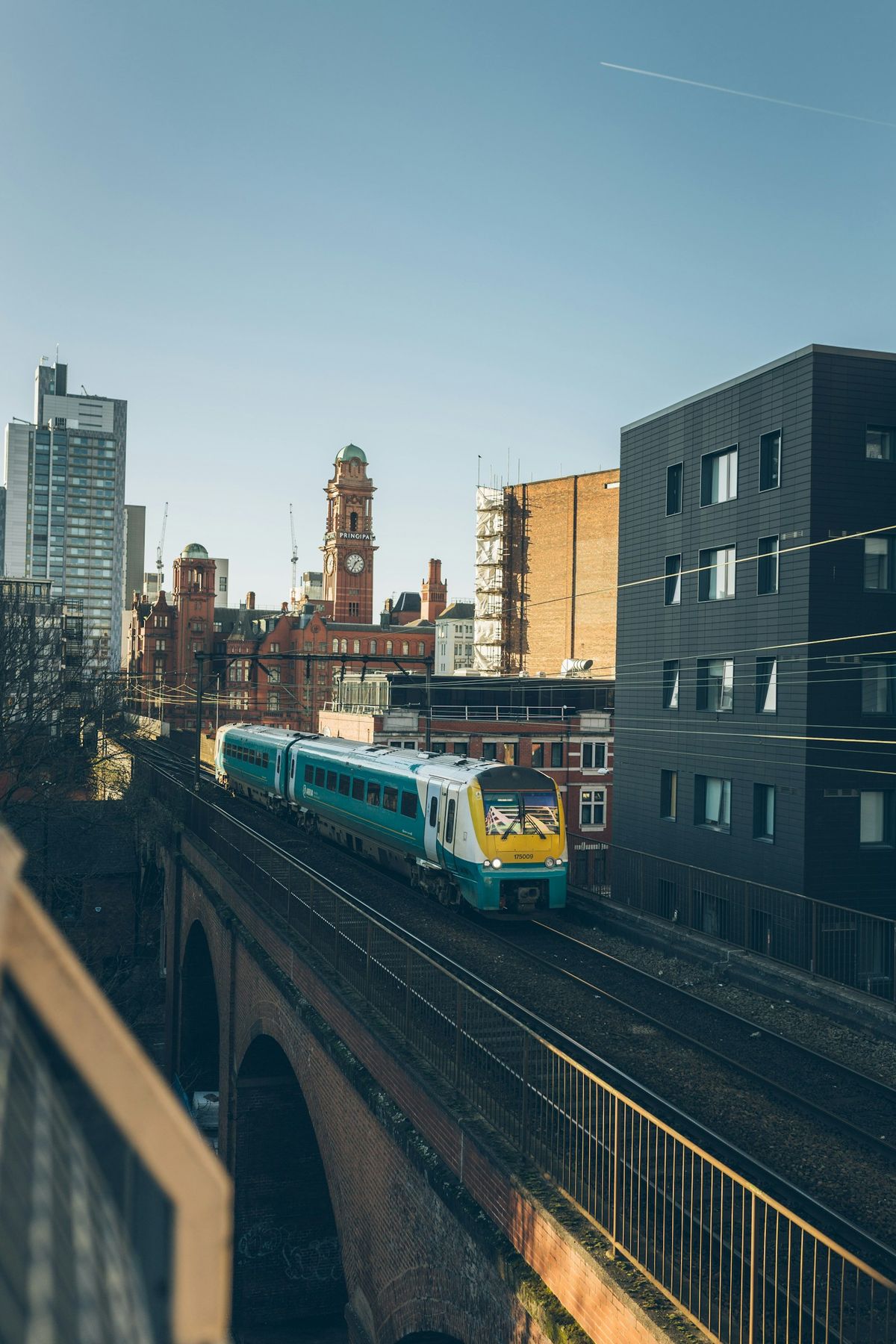 Yellow and green commuter train at station