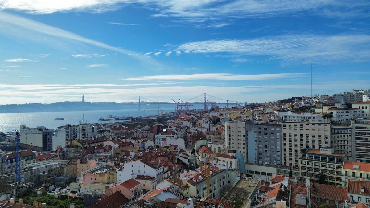 Lisbon city skyline with bridge spanning the Tagus waterway