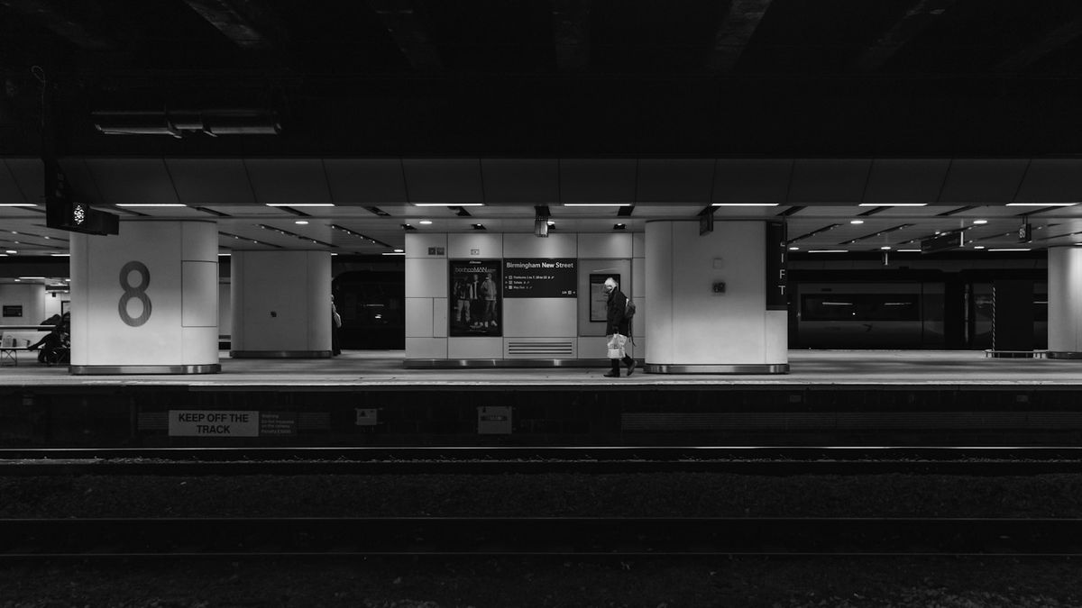 Person standing in a modern UK train station