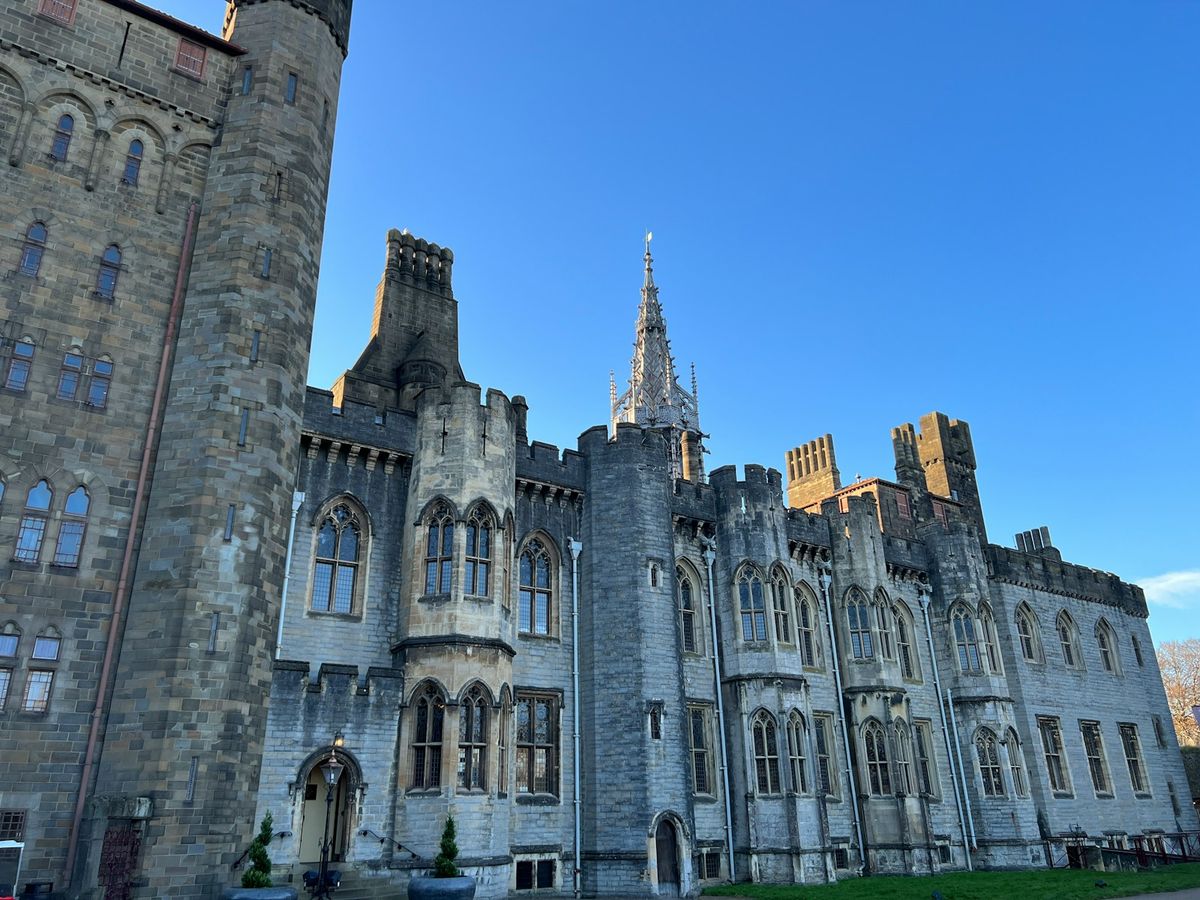 Grand medieval Cardiff Castle under clear blue sky