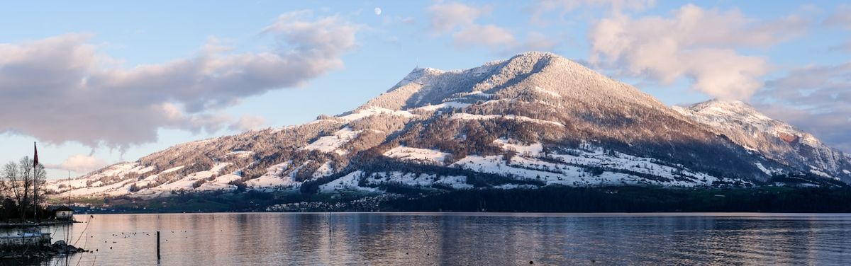 Snow-covered Mount Pilatus rising above a lake near Lucerne