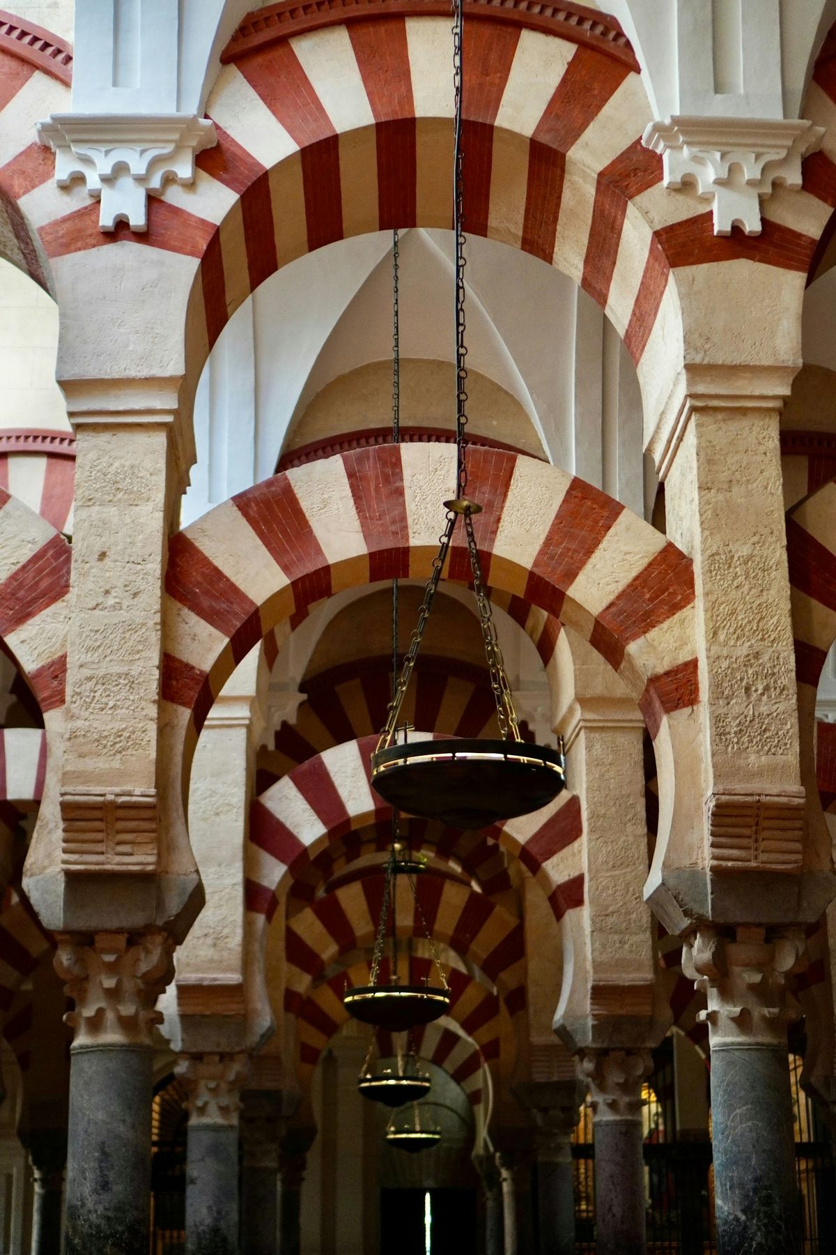 Red and white striped arches inside the Mezquita Cathedral in Cordoba