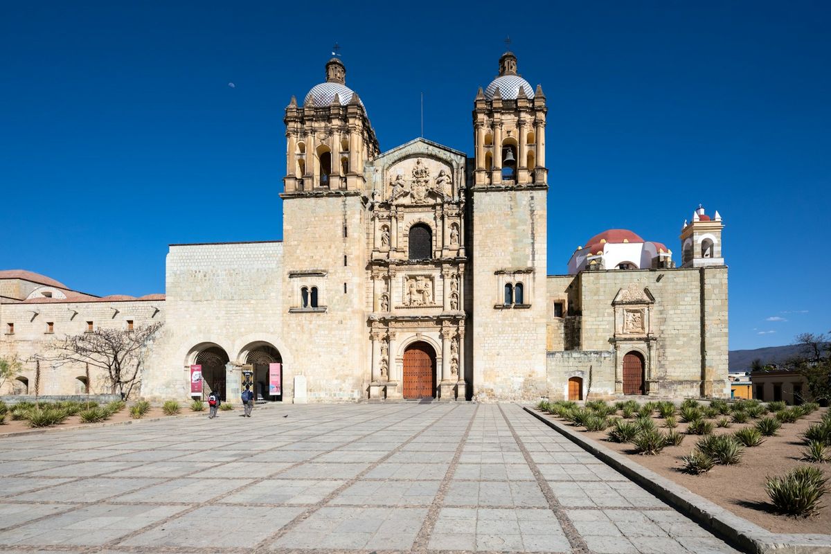 Historic Oaxaca church with ornate baroque facade under blue sky