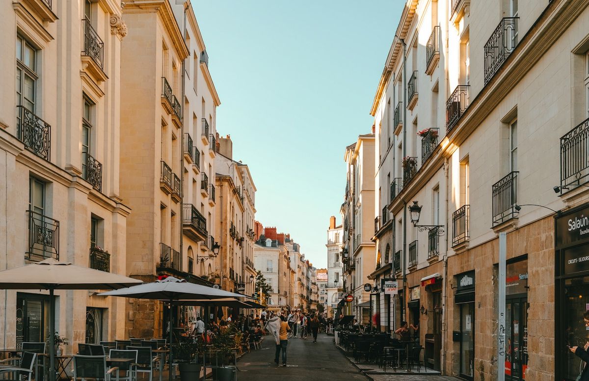Narrow city street lined with tall buildings in Nantes