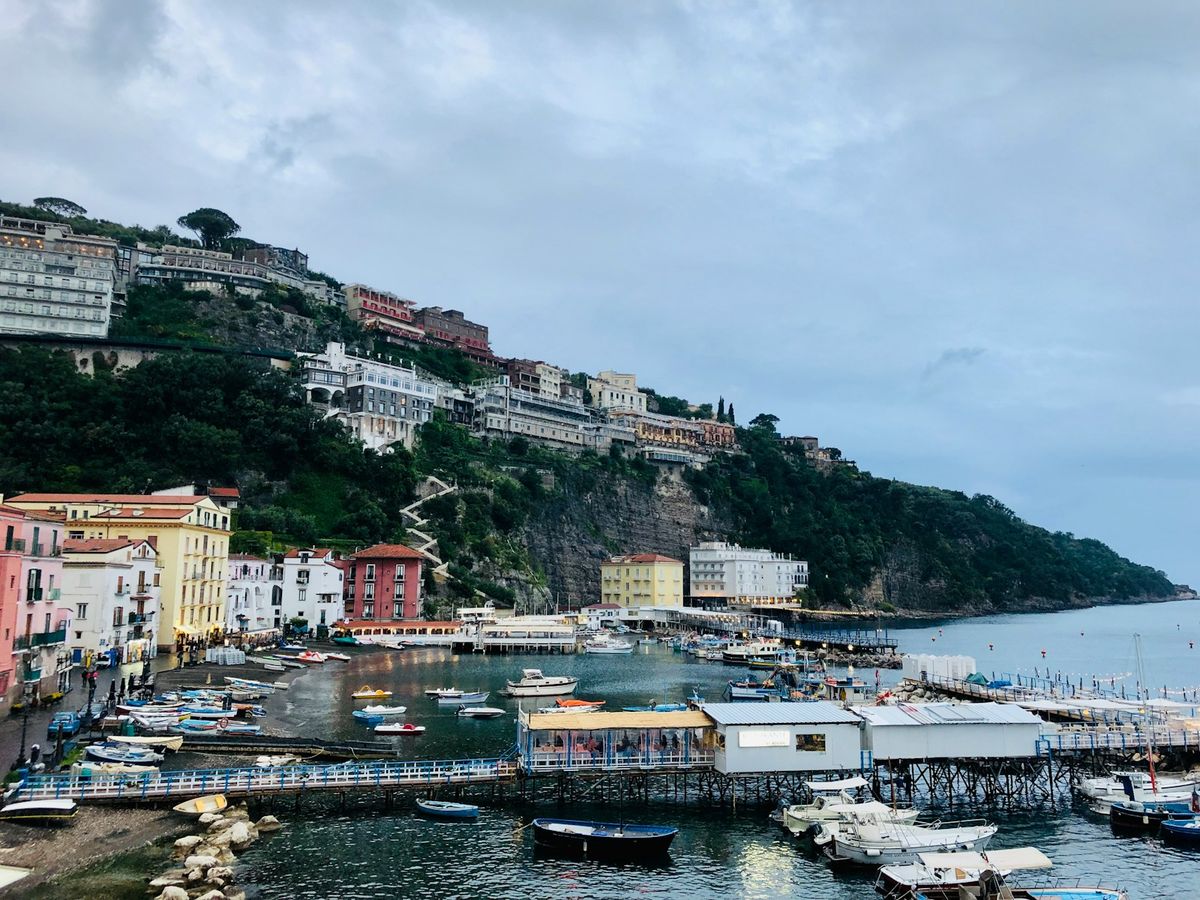 Naples harbor with boats and hillside