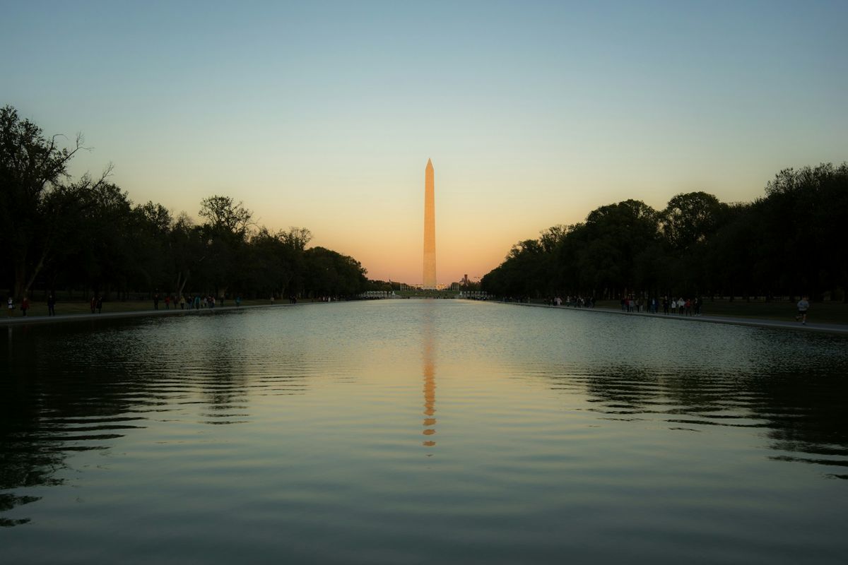 Washington Monument reflected in the water at sunset DC