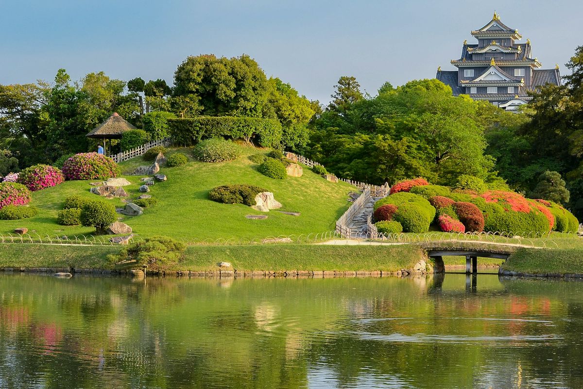Traditional Japanese garden with pond and bridge at Korakuen, Okayama