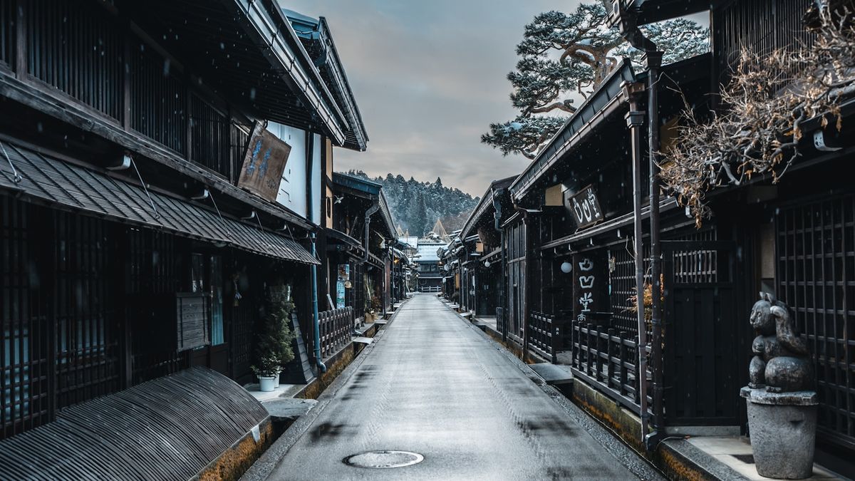 Narrow street lined with traditional wooden buildings in Takayama's old town