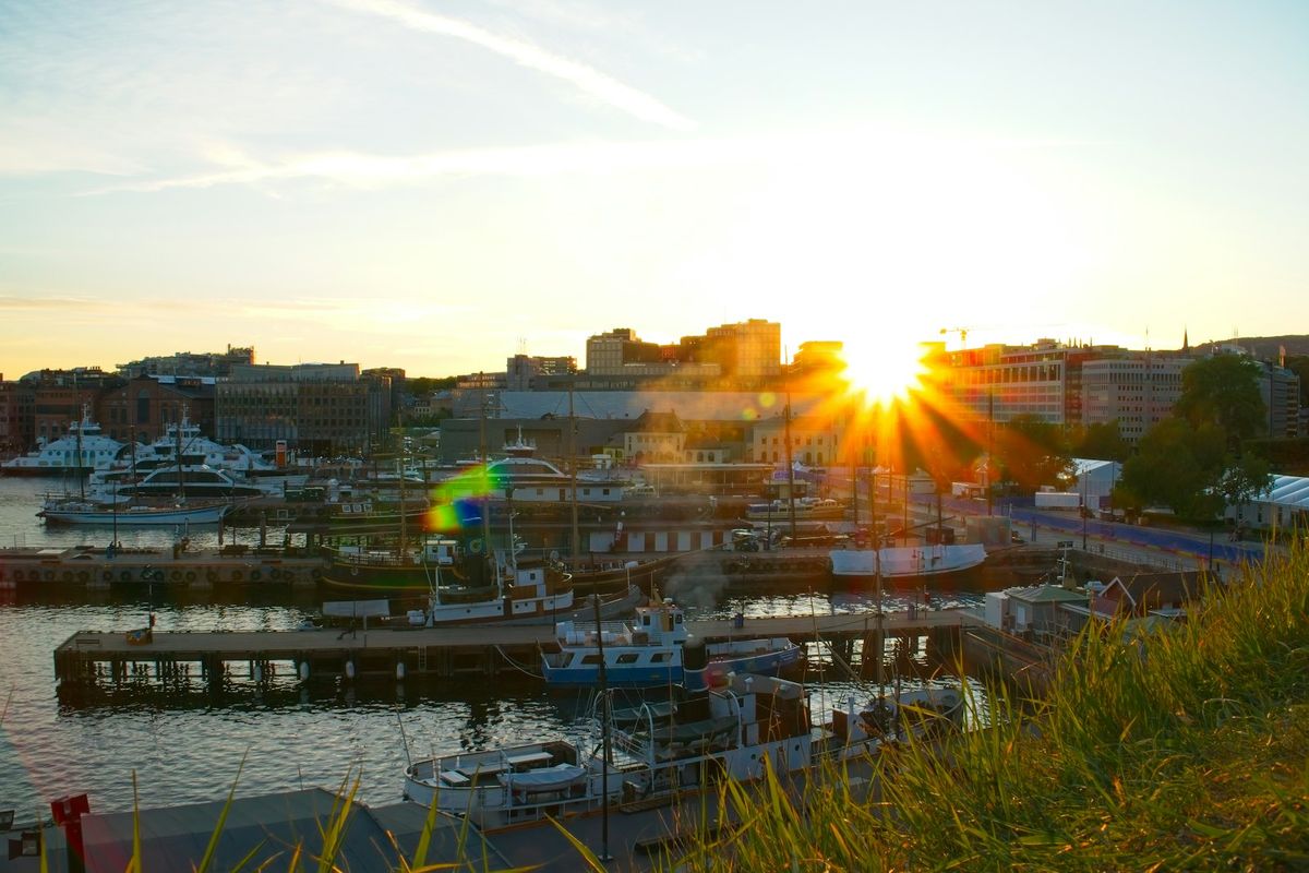 Sunset over the Oslo fjord harbor with boats