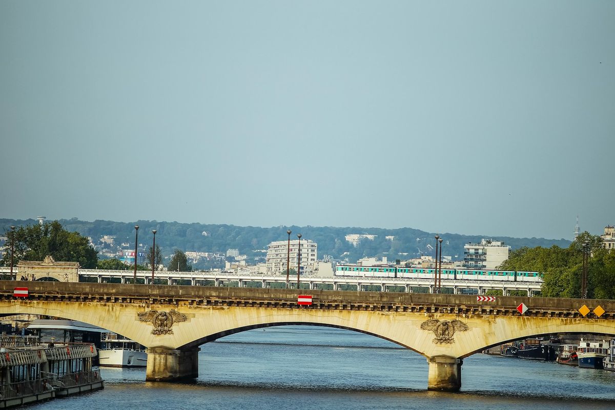 A train crossing a bridge over a European canal
