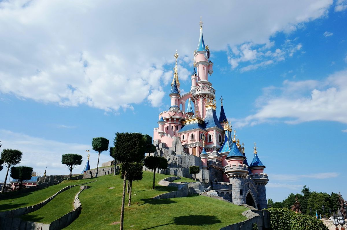 Disneyland Paris castle under blue sky with clouds