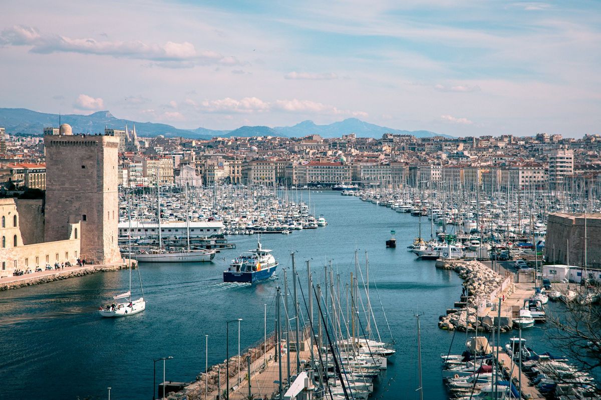 Boats in Marseille harbour with city skyline