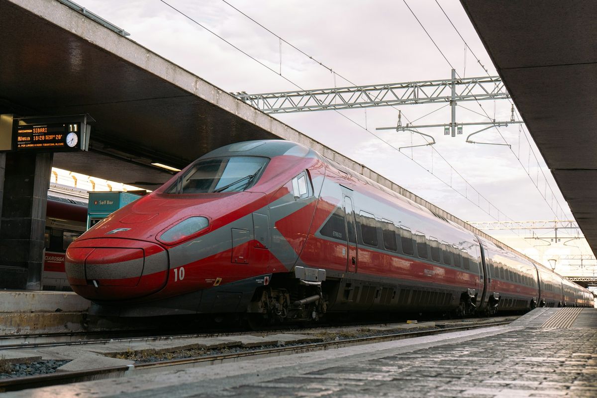 Sleek red Frecciarossa high-speed train at an Italian station