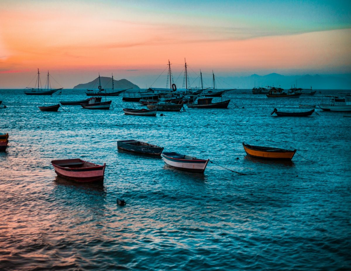 Colourful wooden fishing boats anchored in a bay at Buzios, Brazil