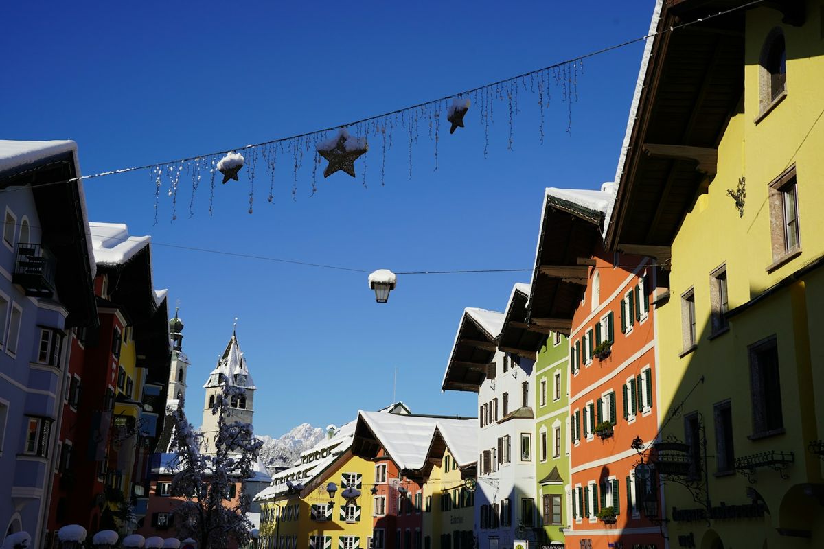 Colorful buildings and clock tower on Kitzbuhel main street