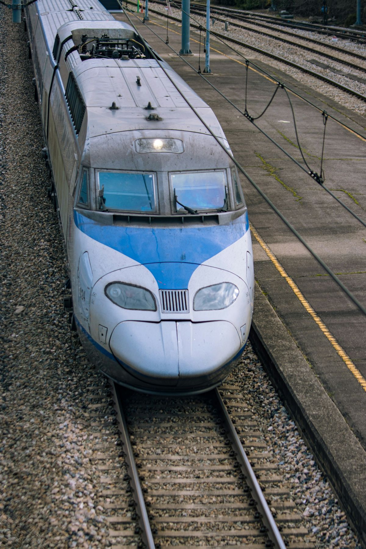 Blue and white KTX high-speed train on tracks in South Korea