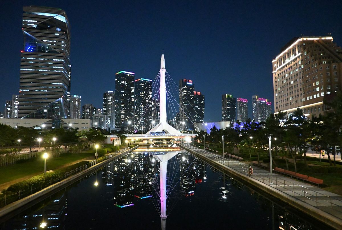Songdo Incheon cityscape with illuminated bridge and water reflections