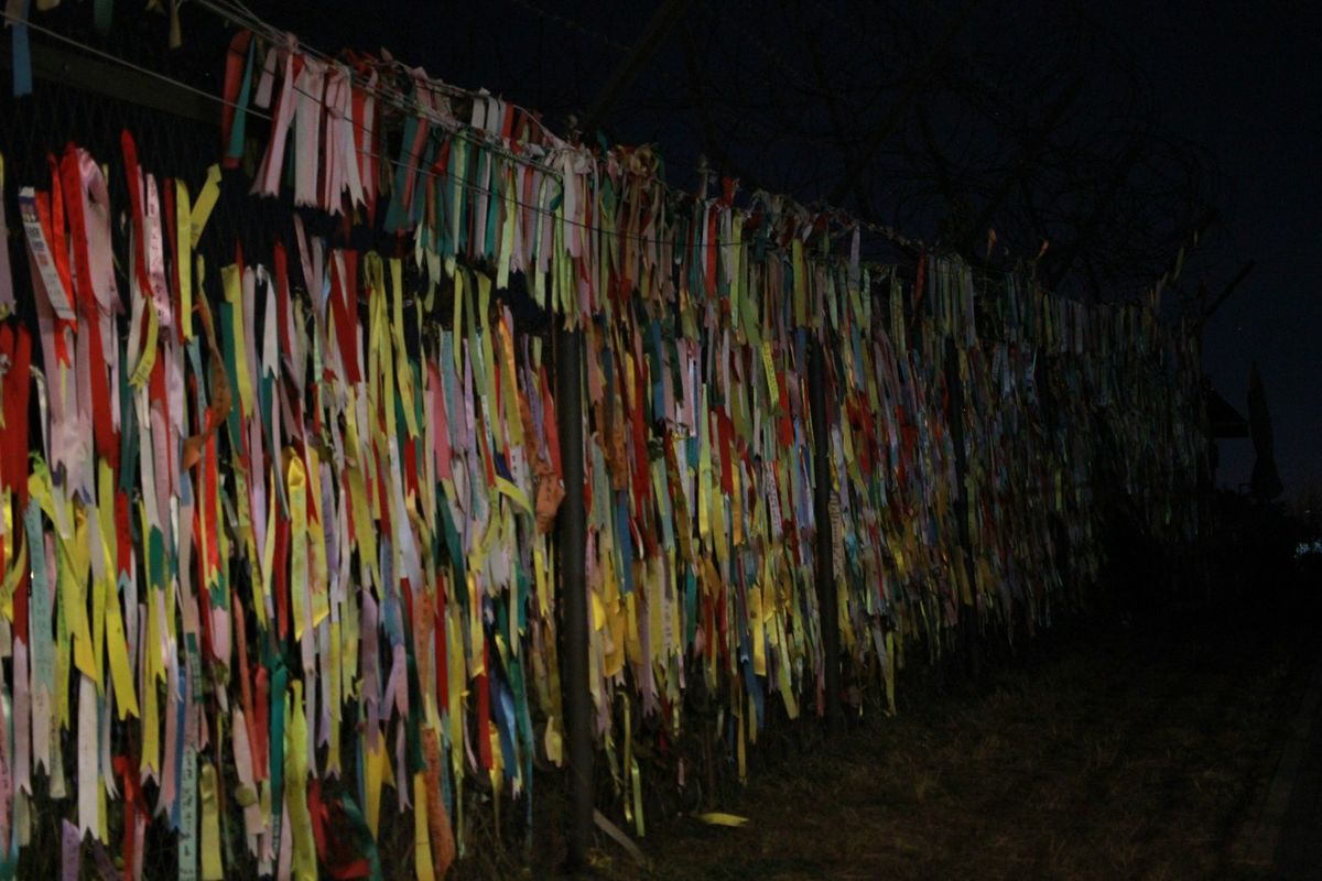Ribbons of hope tied to the wire fence at the Korean DMZ border