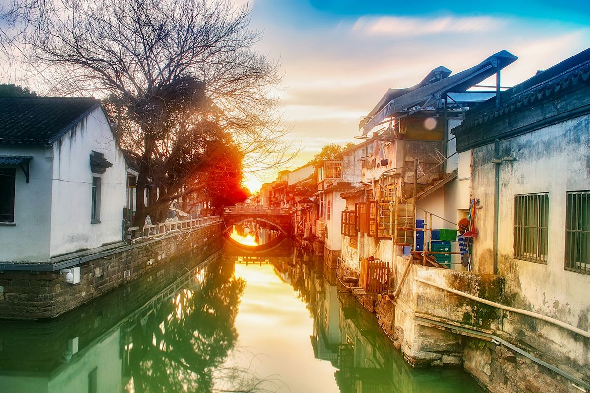 Historic canal with arched bridge in Suzhou, China