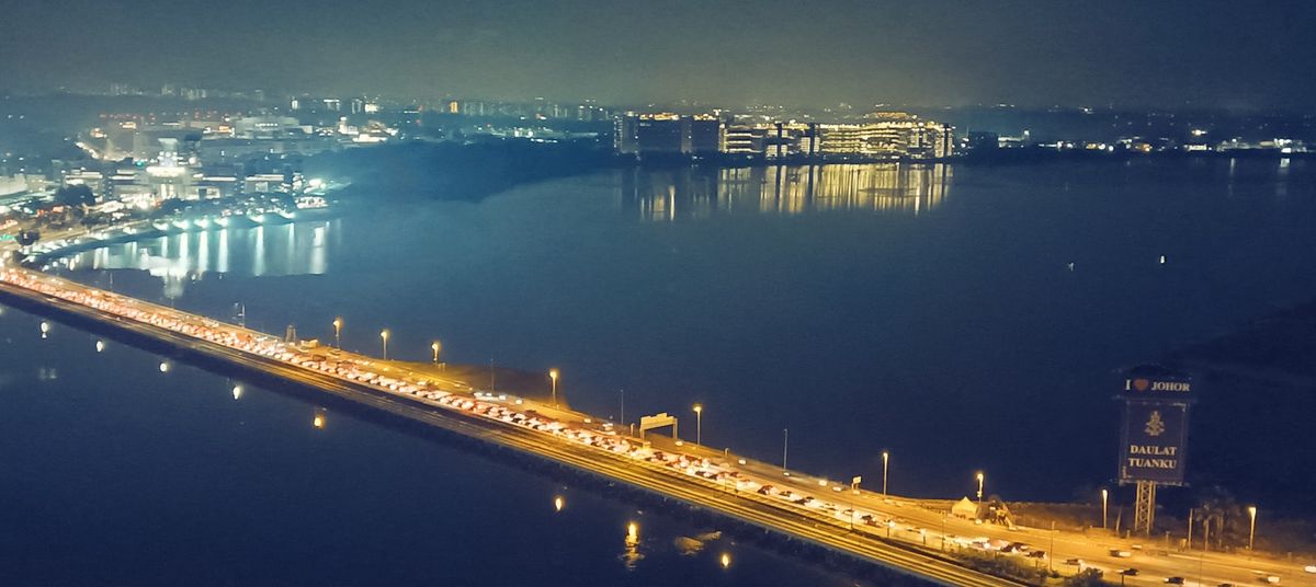 Aerial night view of the waterfront between Johor Bahru and Singapore