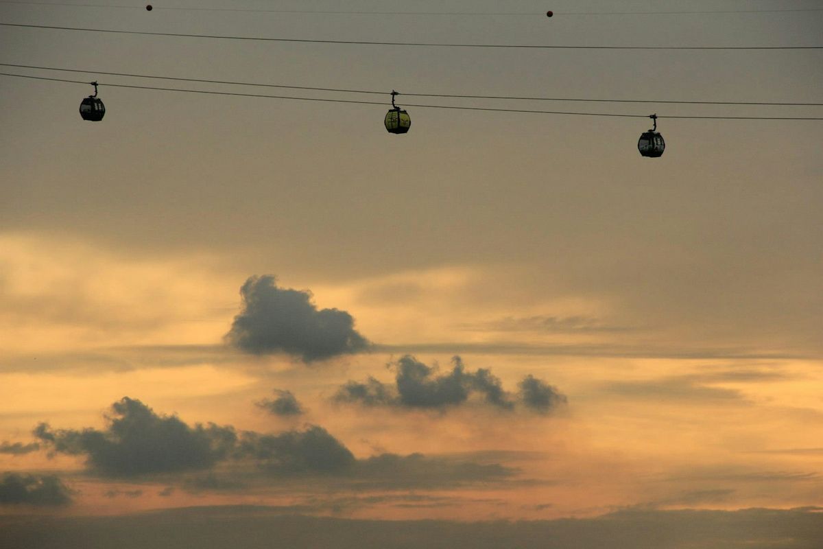 Cable cars over Sentosa Island, Singapore, at sunset