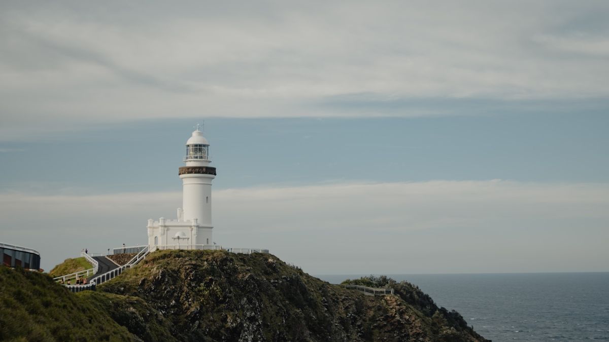 Cape Byron Lighthouse on a rocky cliff overlooking the ocean