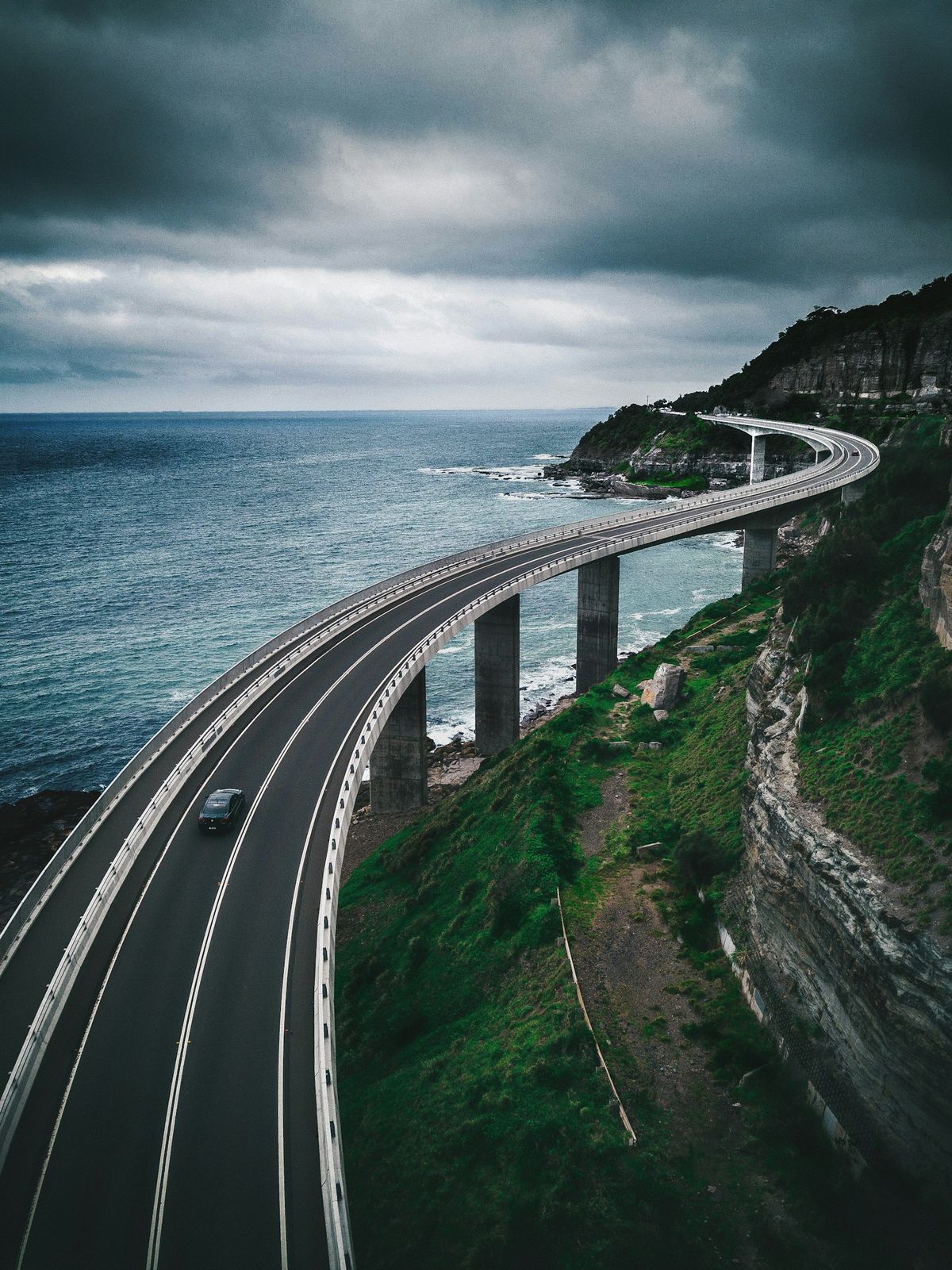 The Sea Cliff Bridge curving along the coast on the Grand Pacific Drive