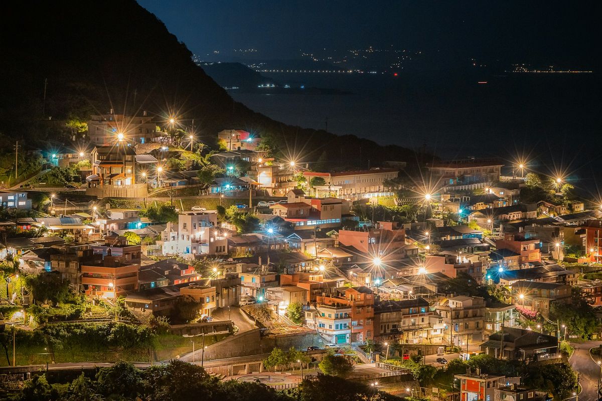 Night view of Jiufen's teahouses lit up on the mountainside Taiwan