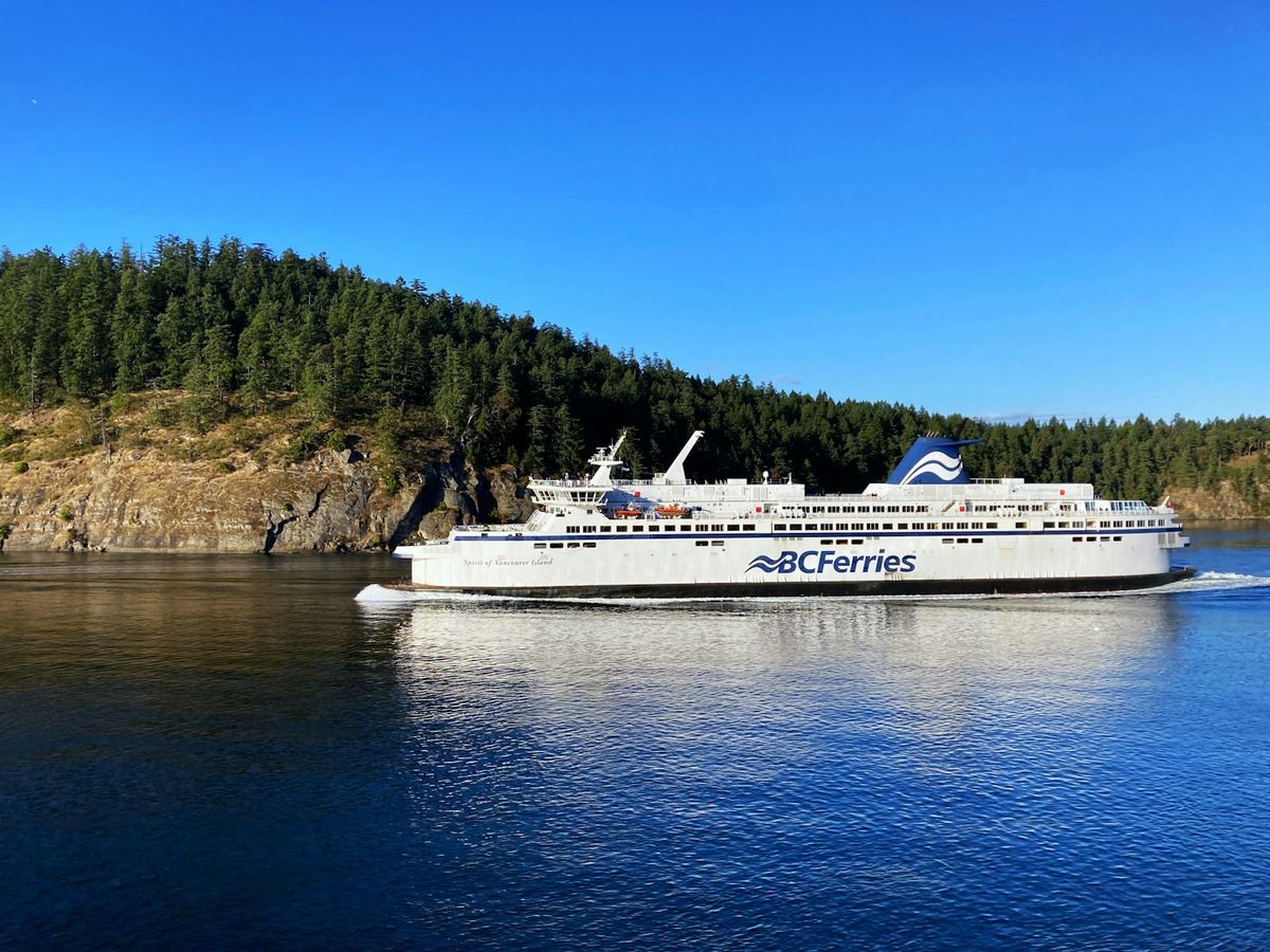 A BC Ferry sailing through the forested Gulf Islands
