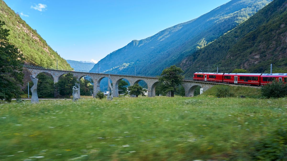 Bernina Express train crossing a bridge in the Swiss Alps