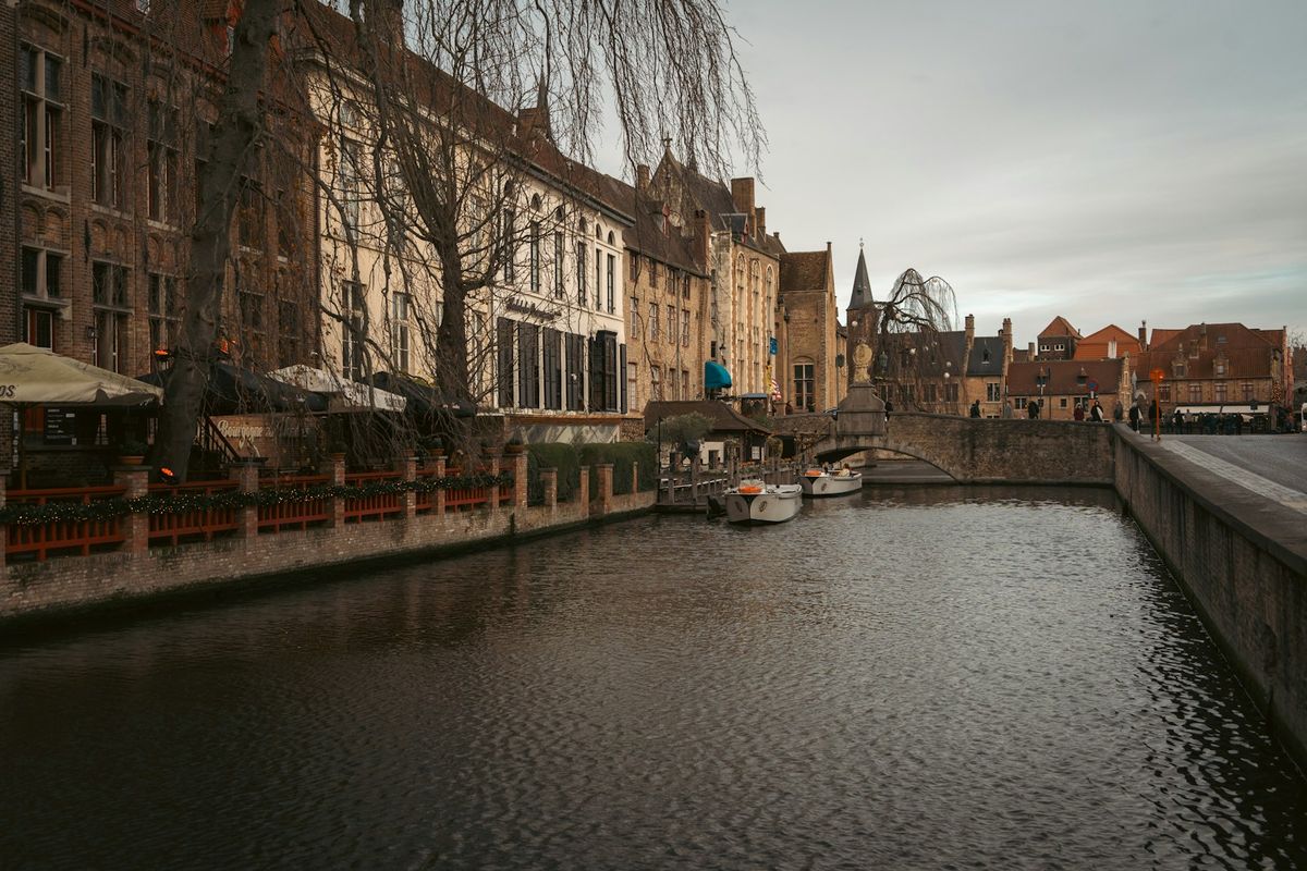 Canal in Bruges with historic buildings and boats
