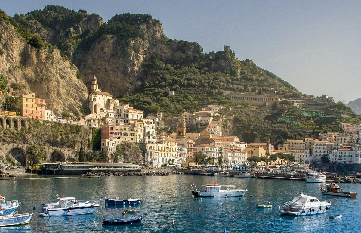 Boat on the water near the mountainous Amalfi Coast, Italy