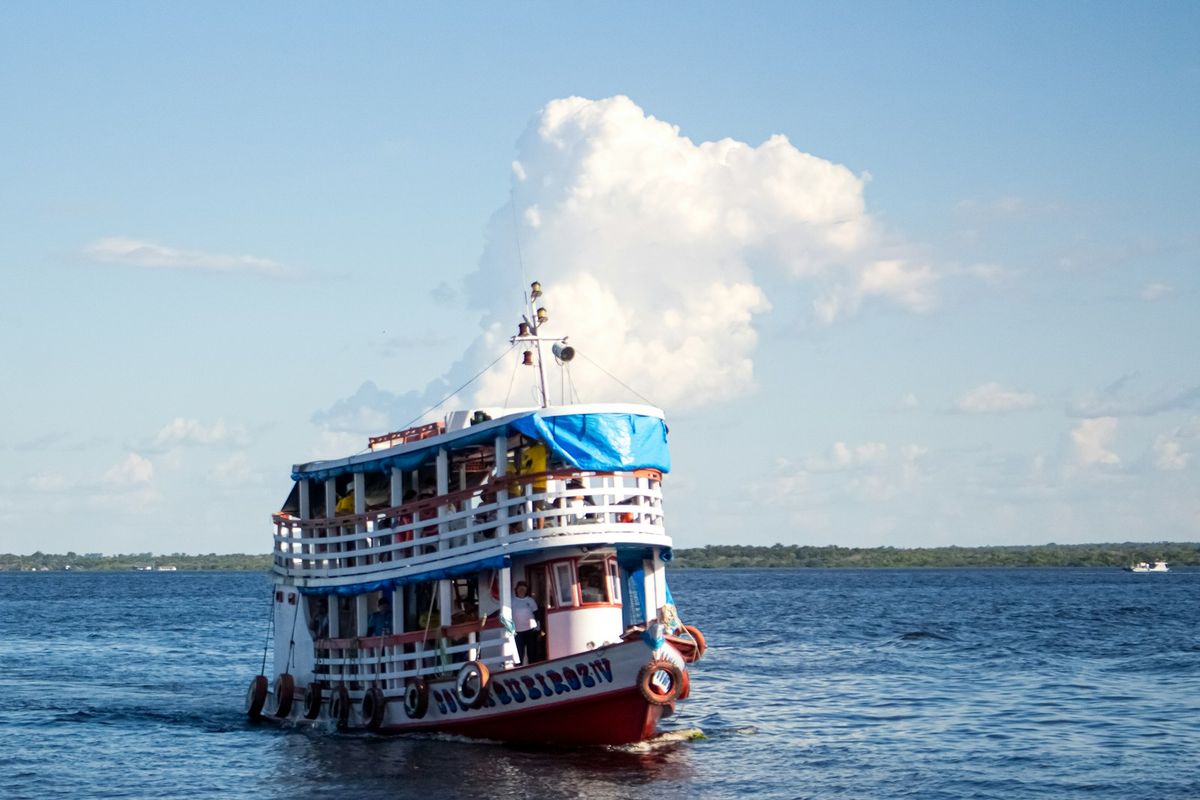 A passenger boat sailing on a wide river in the Amazon, Brazil