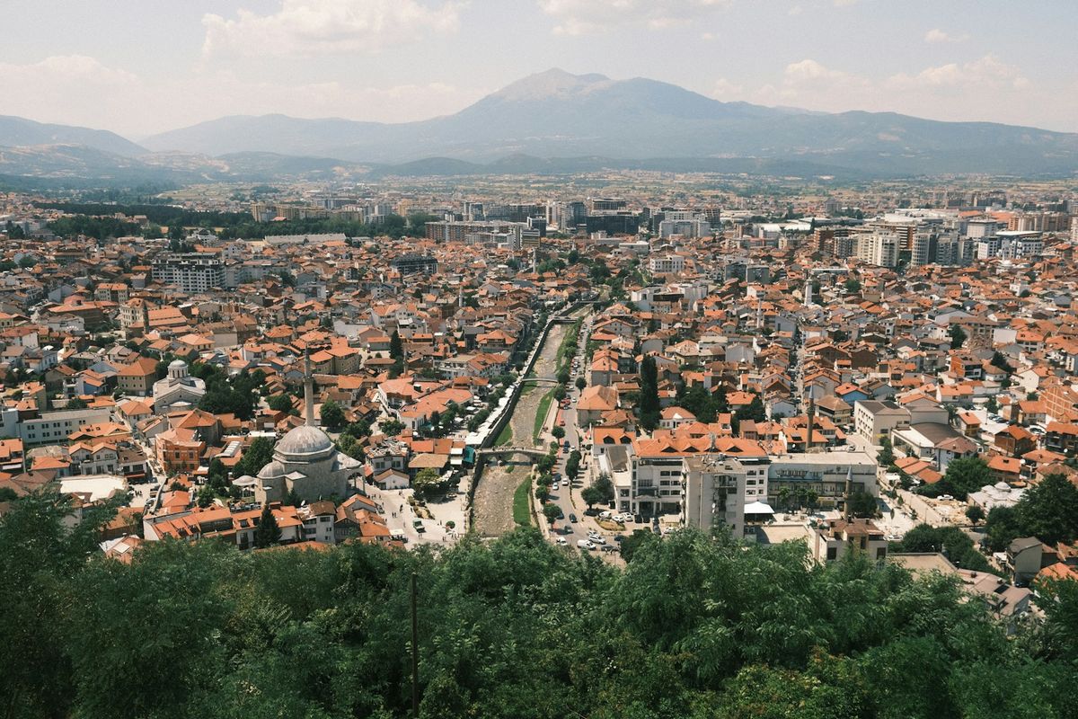 Sprawling Eastern European city with river and distant mountains
