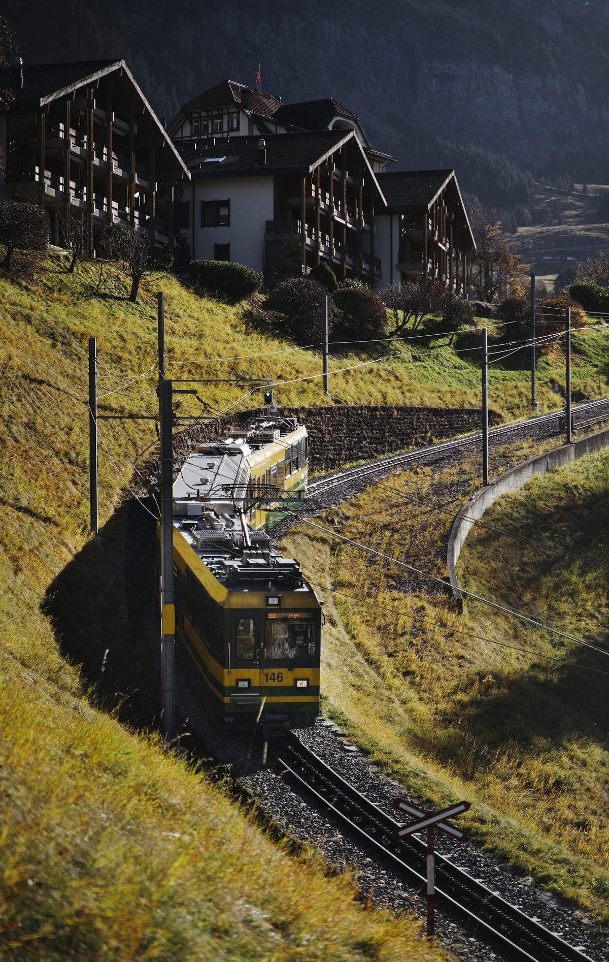 Yellow train on a winding scenic track through Europe