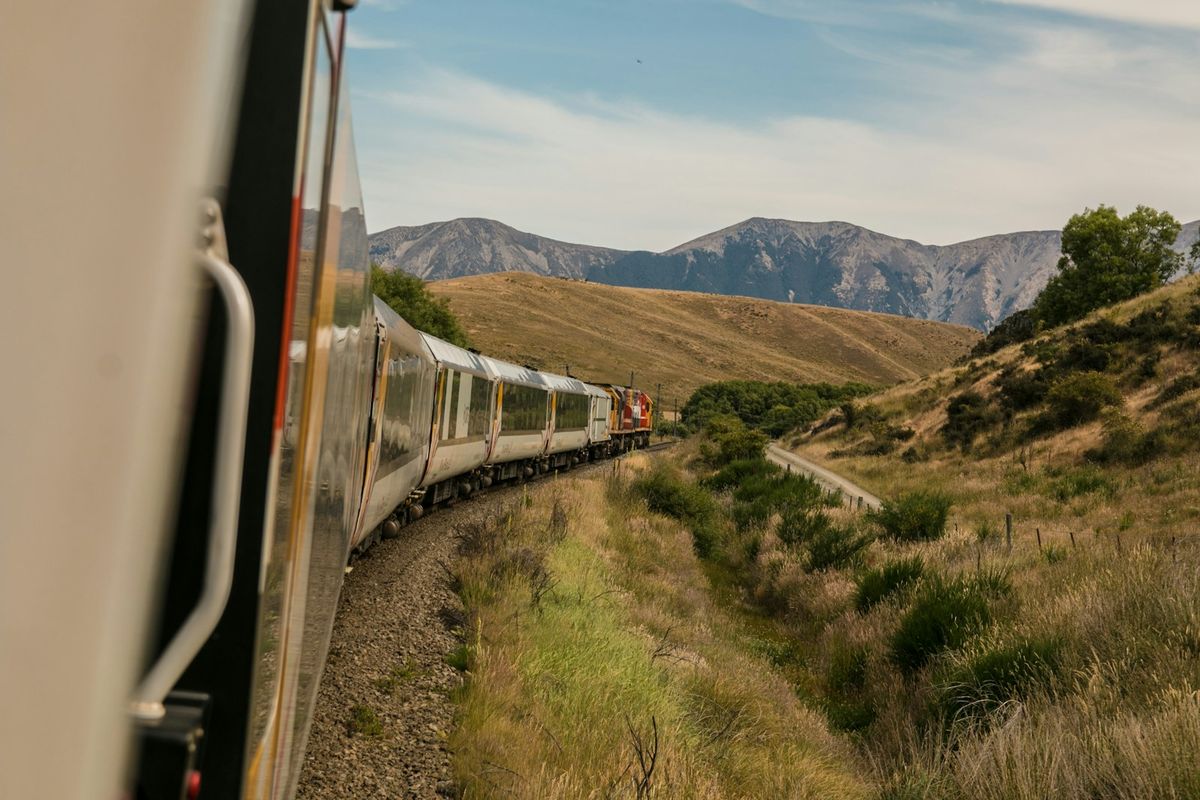 White train with mountains in the background