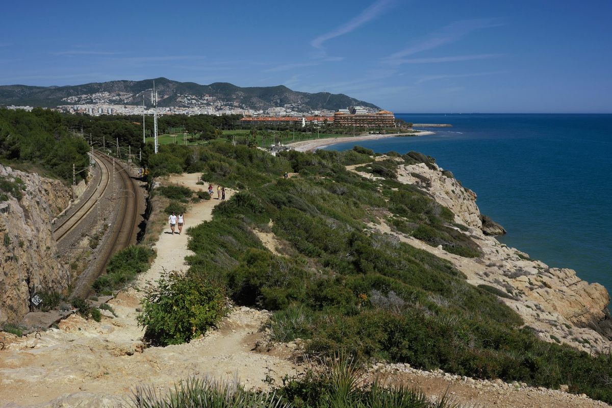 Coastal path with train tracks and ocean view in Iberia