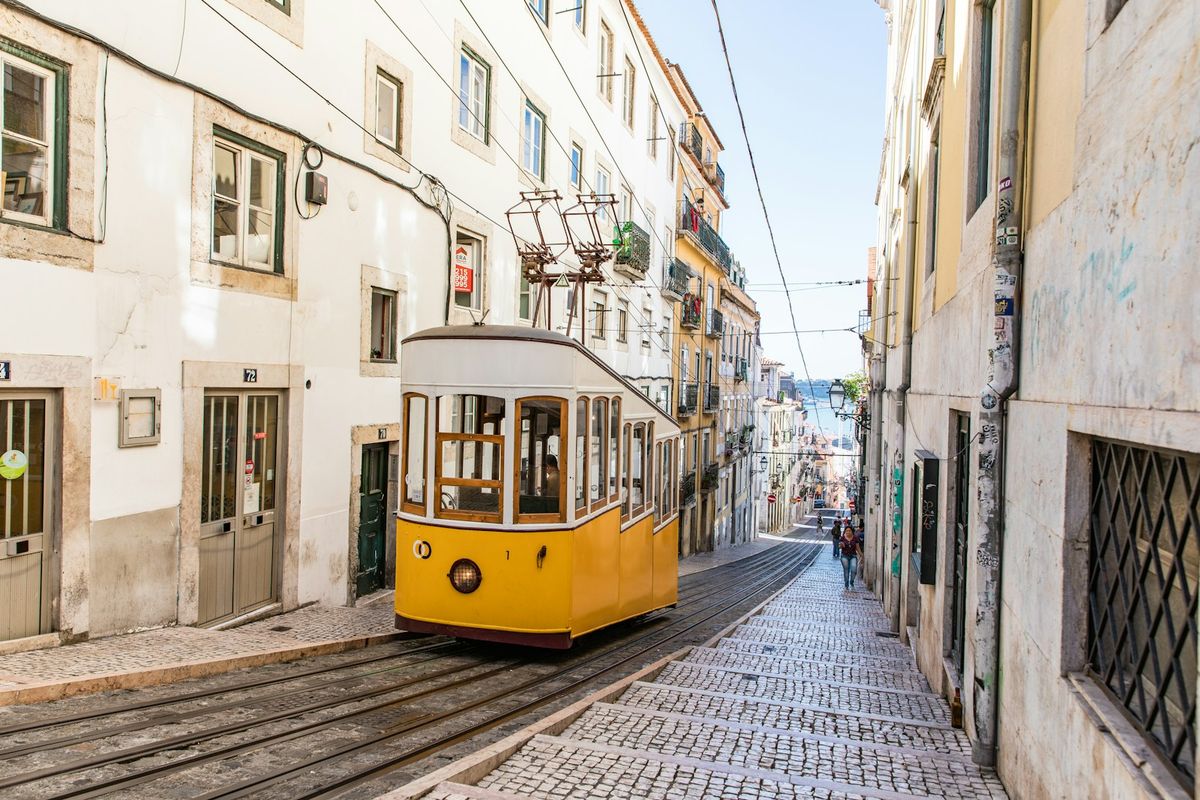 Yellow tram on Lisbon street during daytime