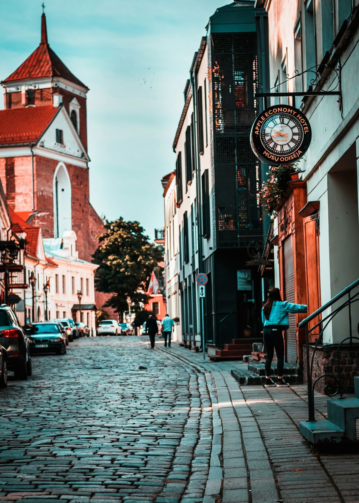 Cobblestone street in Kaunas old town with clock tower
