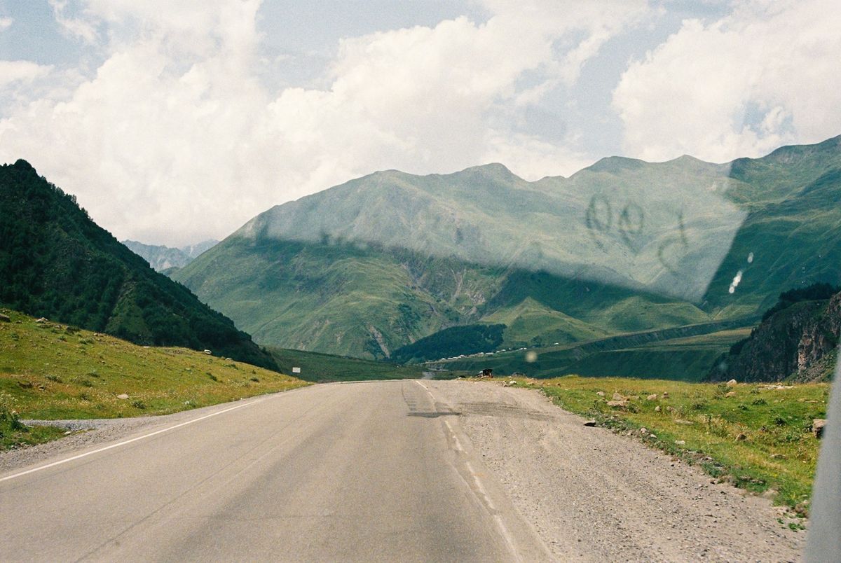 A car driving the Georgian Military Highway through the Caucasus mountains