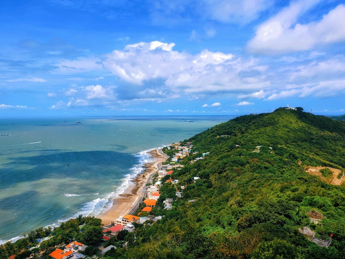 Green coastal mountains overlooking the ocean along Vietnam's coast